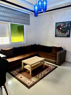a living room with a couch and a coffee table at Apprt in Fès