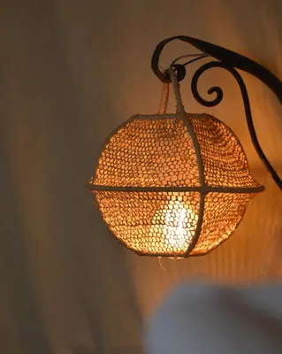 a lamp that is hanging from a wall at Bohem Camp in Merzouga