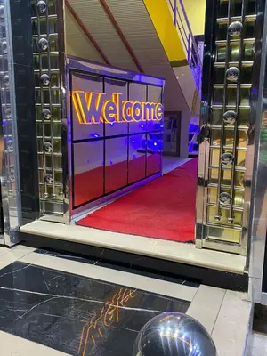 a welcome sign in a room with a red carpet at Hotel Sotchi in Outat Oulad el Hajj