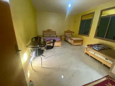 an aerial view of a room with two beds and a table at Hotel Sotchi in Outat Oulad el Hajj