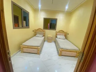 a room with two beds in a room at Hotel Sotchi in Outat Oulad el Hajj