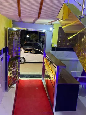 a room with a red carpet and a door with a car at Hotel Sotchi in Outat Oulad el Hajj