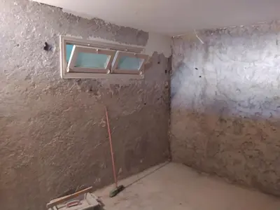 a room with two windows in a room with a wall at Appartement meublé in Meknès