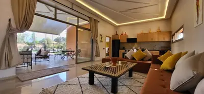 a living room with a couch and a table at Le Jardin de Jeanne in Marrakech