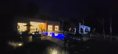 a house with a swimming pool at night at Le Jardin de Jeanne in Marrakech