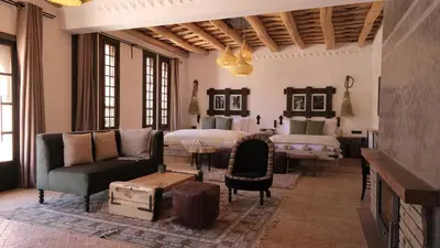 a living room with a couch and a bed at Eden Boutique Hotel in Tamellalt