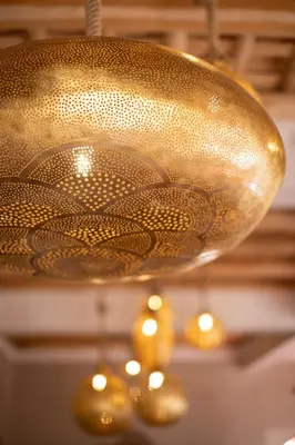a large copper pot hanging from a ceiling at Eden Boutique Hotel in Tamellalt