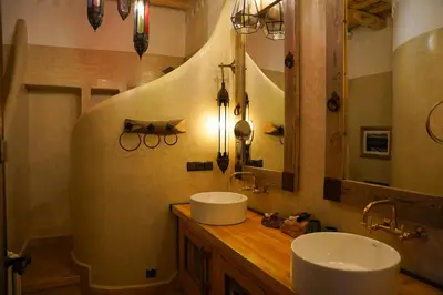 a bathroom with two sinks on a wooden counter at Eden Boutique Hotel in Tamellalt