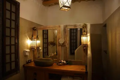 a bathroom with a sink and a mirror at Eden Boutique Hotel in Tamellalt