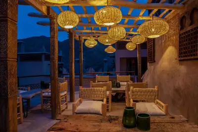 a patio with chandeliers and a table and chairs at Eden Boutique Hotel in Tamellalt