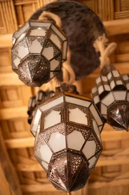a group of lights hanging from a ceiling at Eden Boutique Hotel in Tamellalt