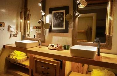 a bathroom with two sinks and a mirror at Eden Boutique Hotel in Tamellalt