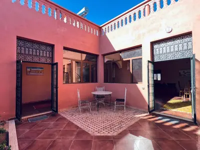 a courtyard of a house with a table and chairs at Family villa with swimming pool and a wonderful mountain view Family Only in Marrakech