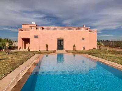 a house with a pool in front of a building at Family villa with swimming pool and a wonderful mountain view Family Only in Marrakech
