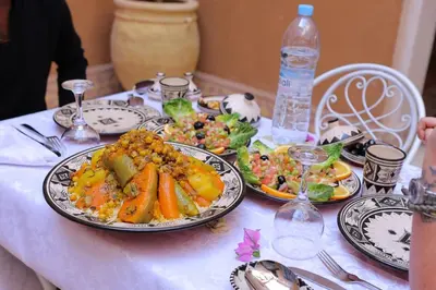 a table with plates of food on top of it at Riad Dar Susan - Authentic Stay in Zagora in Zagora