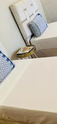 a room with two beds and a table next to a bed at villa ezzaouak in Marrakech