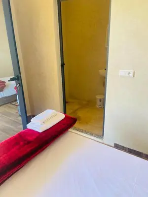a bathroom with a mirror and a red towel at villa ezzaouak in Marrakech