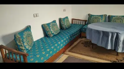 a couch with pillows on it in a room at شقة في البادية الهدوء والطبيعة نواحي فاس مكناس in Fès