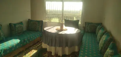 a room with two chairs and a table and a window at شقة في البادية الهدوء والطبيعة نواحي فاس مكناس in Fès