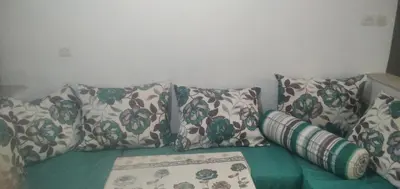 a couch with four pillows on it at شقة في البادية الهدوء والطبيعة نواحي فاس مكناس in Fès