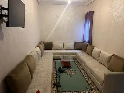 a living room with a couch with a table at Appartement à marjane in Meknès