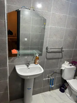 a bathroom with a sink and a toilet at Appartement à marjane in Meknès
