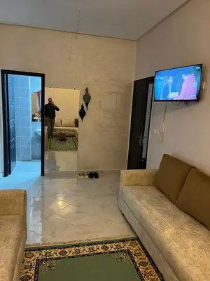 a man taking a picture of a living room at Appartement à marjane in Meknès