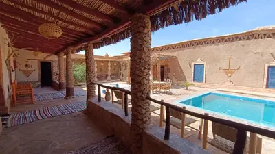an outdoor patio with a swimming pool in a house at kasbah luna del sur in Erfoud
