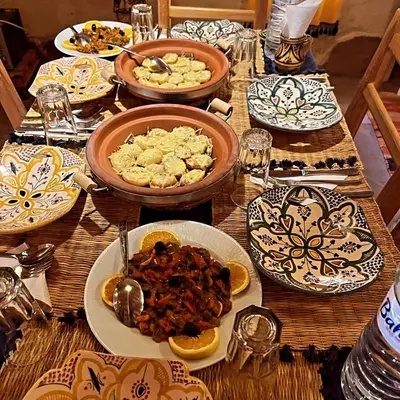 a wooden table with plates of food on it at kasbah luna del sur in Erfoud