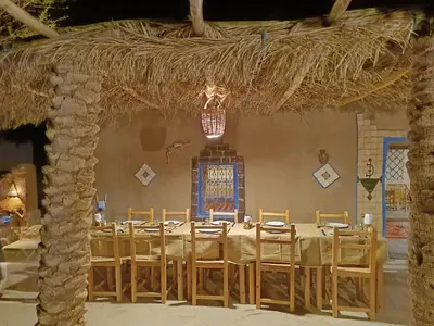 a dining room with a long table and chairs at kasbah luna del sur in Erfoud