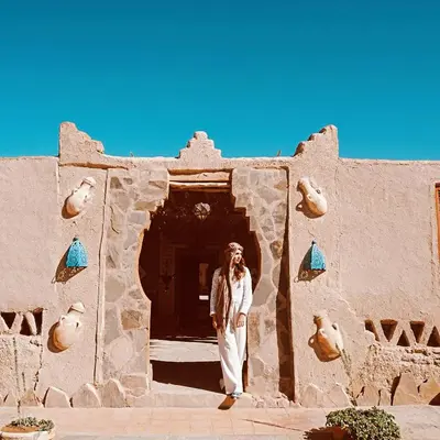 a man standing in front of a building at kasbah luna del sur in Erfoud
