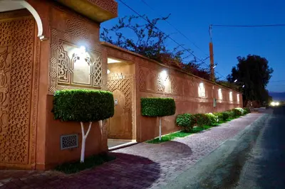 a building with lights on the side of a street at *Villa de luxe à Marrakech, vue sur les montagnes* in Marrakech