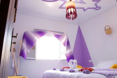 a bedroom with two beds and a window at Ecolodge Aroma Dades in El Hart