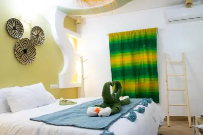 a childs bedroom with a stuffed dinosaur on a bed at Ecolodge Aroma Dades in El Hart