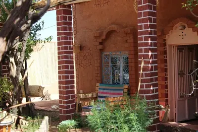 an entry to a brick house with a door at Ecolodge Aroma Dades in El Hart