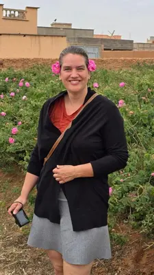 a woman is standing in a field of flowers at Ecolodge Aroma Dades in El Hart