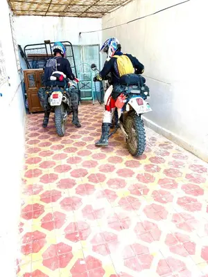 two people on motorcycles parked in a building at Wadahab House An Ideal Retreat for Families and Friends in Er Rachidia