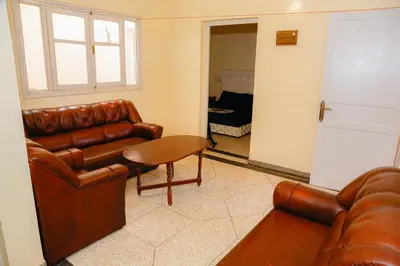 a living room with a leather couch and a table at Wadahab House An Ideal Retreat for Families and Friends in Er Rachidia