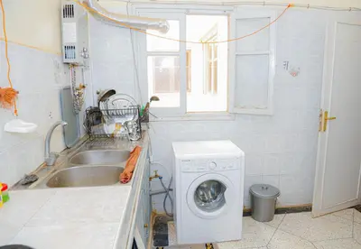 a kitchen with a washing machine and a sink at Wadahab House An Ideal Retreat for Families and Friends in Er Rachidia