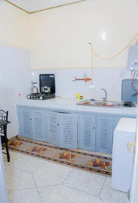 a kitchen with blue cabinets and a sink at Wadahab House An Ideal Retreat for Families and Friends in Er Rachidia