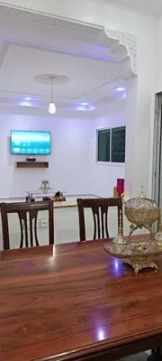 a dining room and kitchen with a wooden table at Fes Panoramic Luxury Apartments in Fès