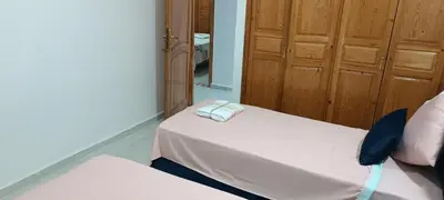 a bedroom with a white bed with a mirror at Fes Panoramic Luxury Apartments in Fès