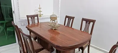 a dining room table with chairs and a lamp on it at Fes Panoramic Luxury Apartments in Fès