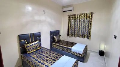 a bedroom with two beds and a window at Fes Panoramic Luxury Apartments in Fès