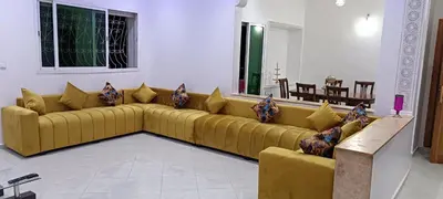 a large yellow couch in a living room at Fes Panoramic Luxury Apartments in Fès