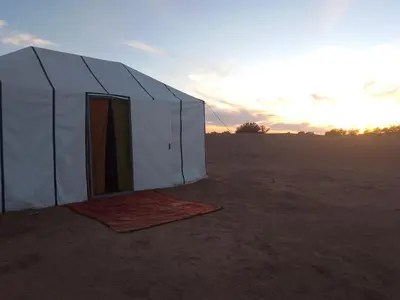 a tent in the middle of the desert at Trek Plan Camp in Mhamid
