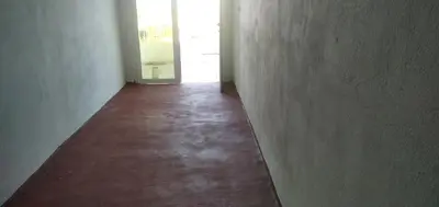 an empty hallway with a red floor in a building at Familles avec bébé in Fès