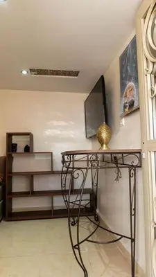 a room with a glass table with a shelf at Dar Benjelloun in Fès