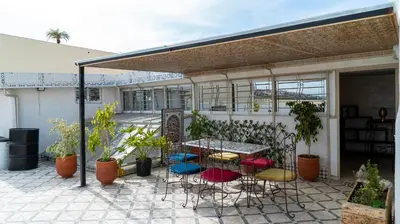 a patio with a table and chairs and plants at Dar Benjelloun in Fès