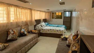 a living room with a couch and a bed at Dar Benjelloun in Fès